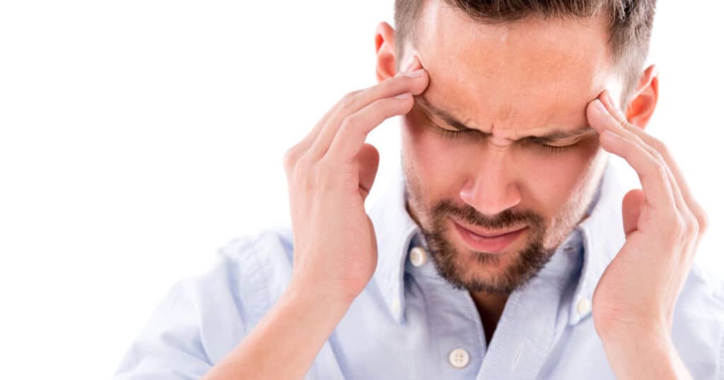 Man experiencing neck pain holding head, demonstrating cervical traction therapy.